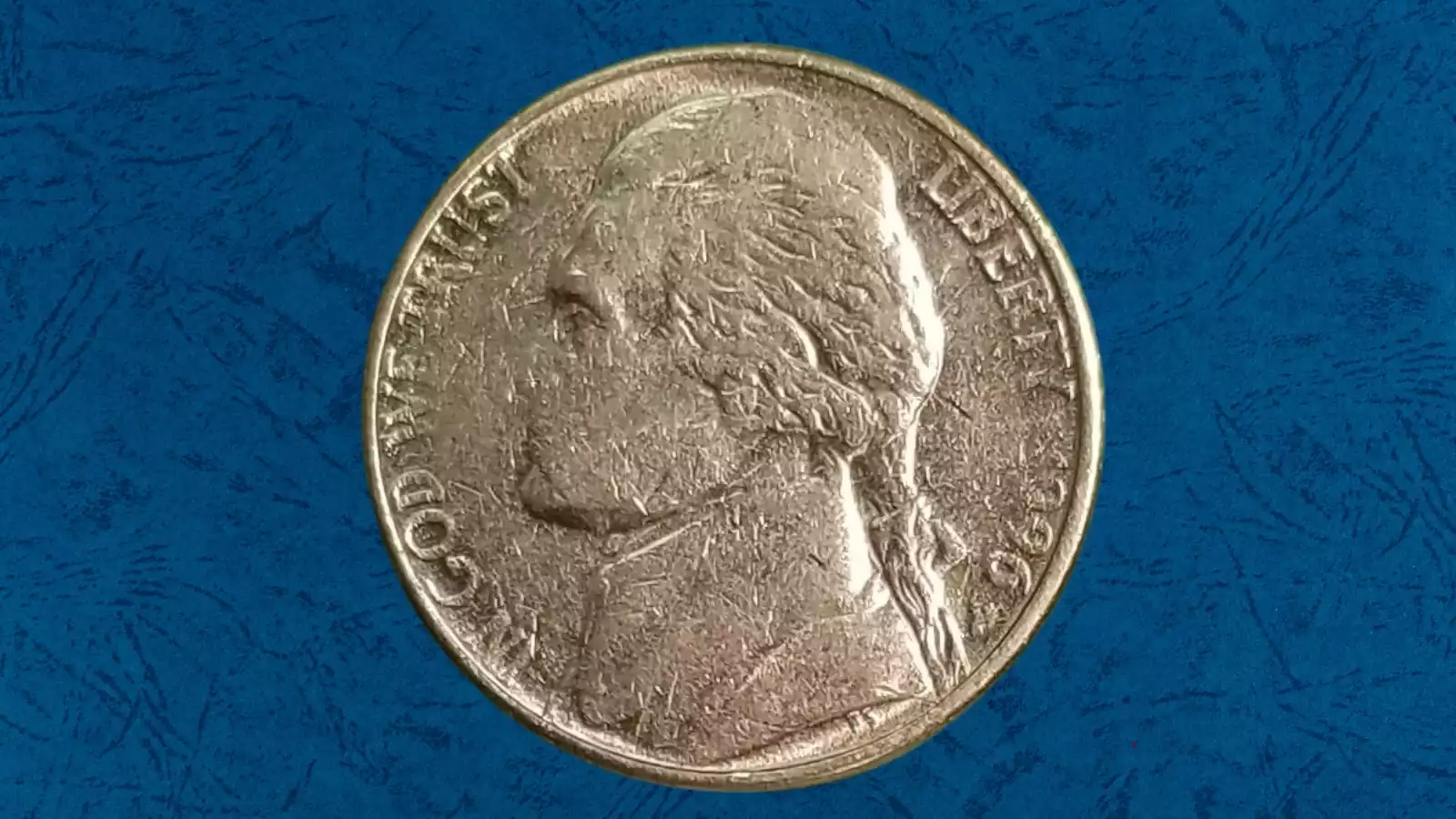 1996 Jefferson nickel struck on a dime planchet — noticeably smaller and thinner than a standard nickel, with design flowing to edge