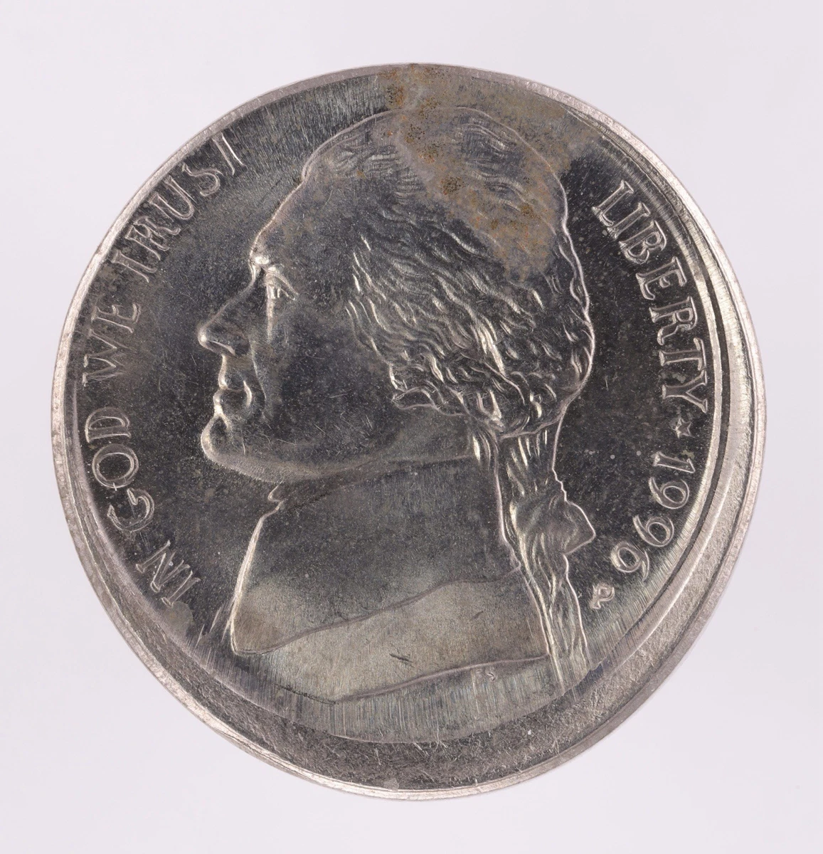 1996 Jefferson nickel with off-center strike error — design shifted with large blank crescent on one side, date still fully visible